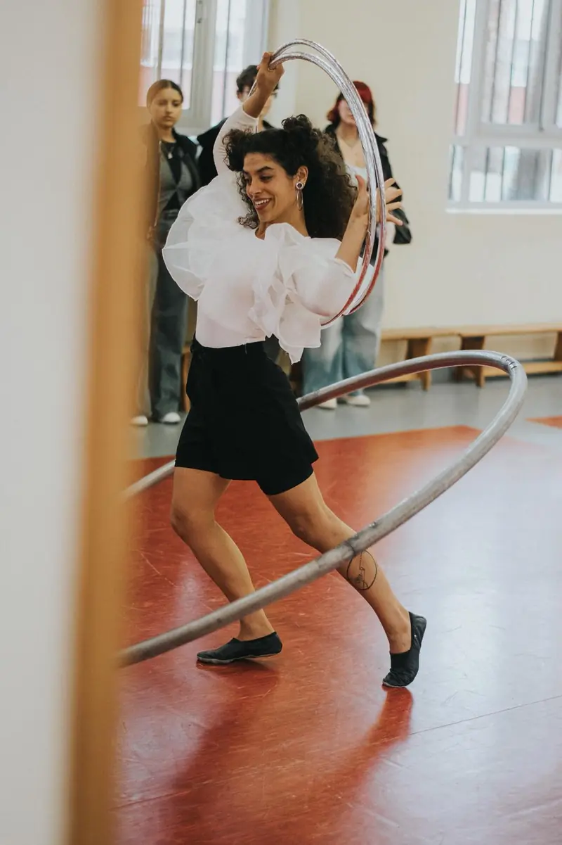 Tami ensayando con la rueda Cyr en la sala.